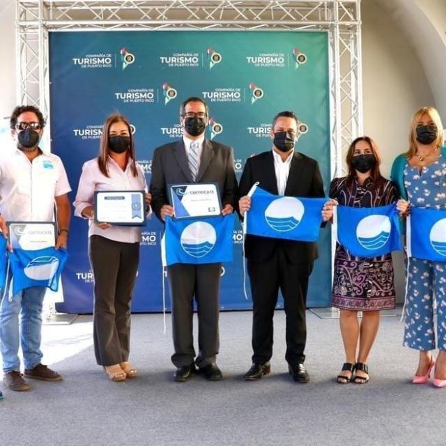 a group of people standing in front of a crowd posing for the camera